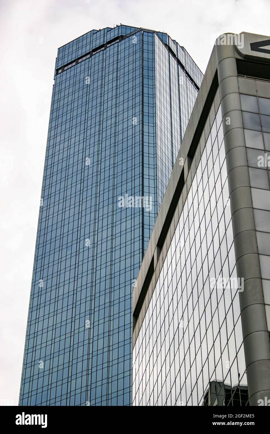 Glass skyscraper towers reflecting the overcast sky Stock Photo