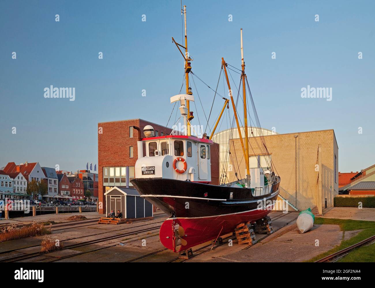 Hildegard buoy tender, museum ship in the inland port, behind it the New Town Hall , Germany, Schleswig-Holstein, Northern Frisia, Husum Stock Photo