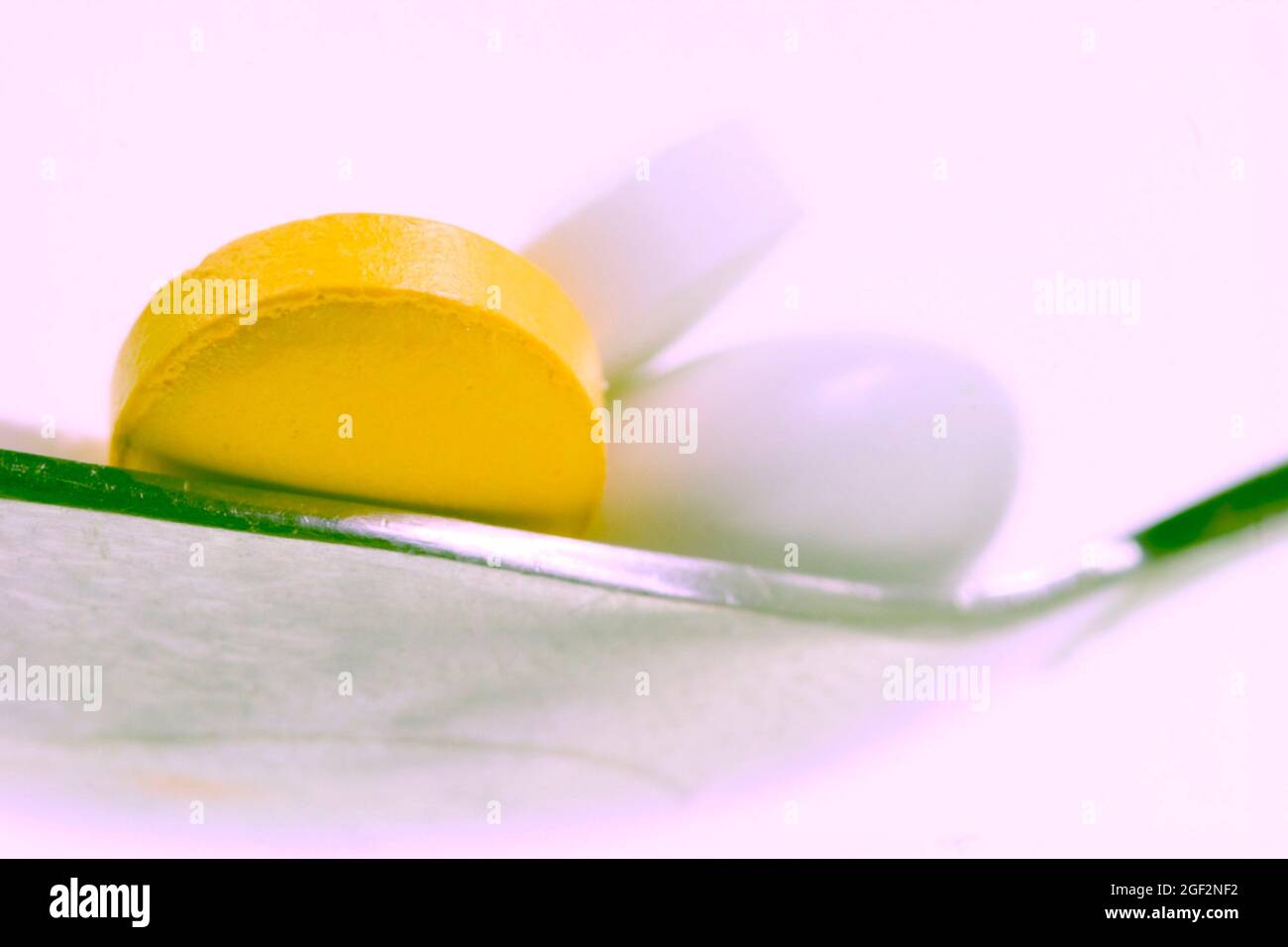 pills on a spoon Stock Photo