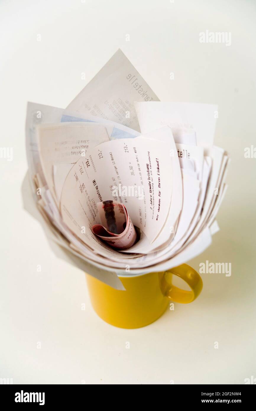 voucher and money in a coffee cup Stock Photo