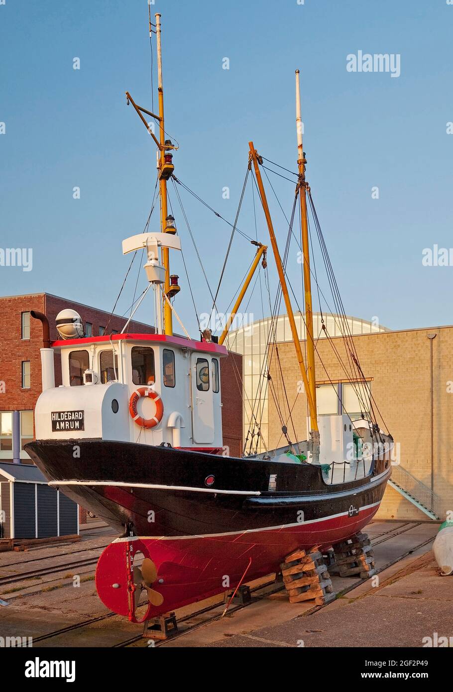 Hildegard buoy tender, museum ship in the inland port, behind it the New Town Hall , Germany, Schleswig-Holstein, Northern Frisia, Husum Stock Photo