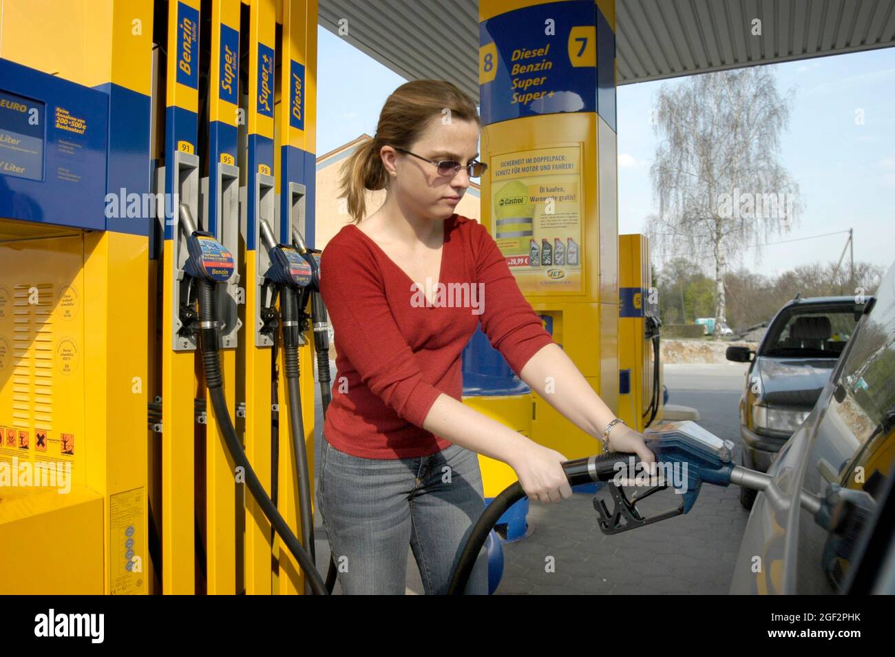 filling up female car driver at the petrol pump, Germany Stock Photo