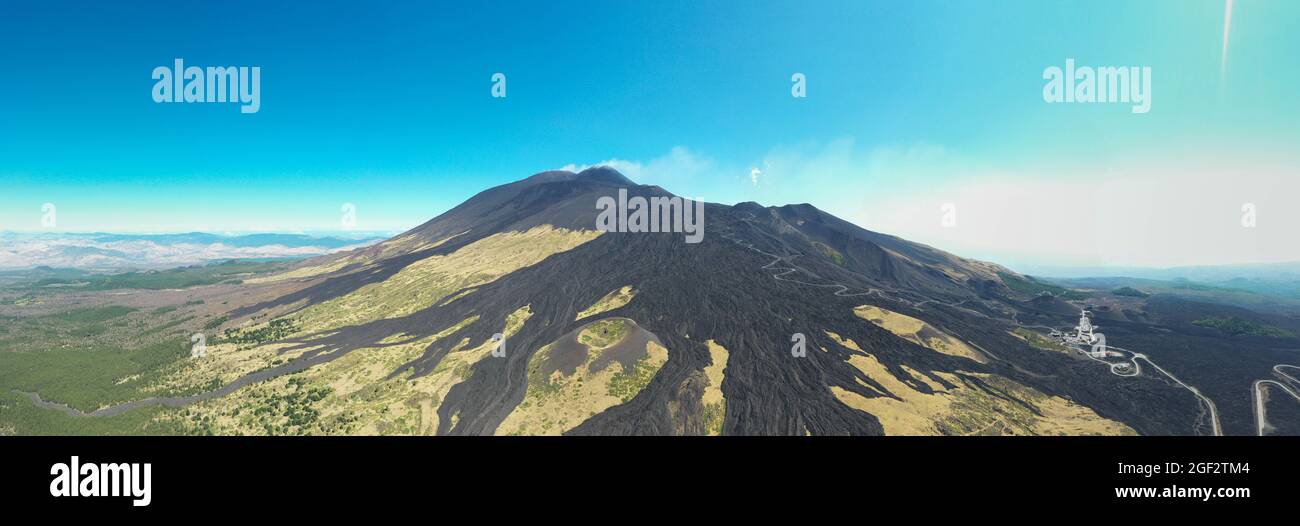 Etna volcano with old lava flow  in a aerial panoramic view from above during sunny day. Stock Photo