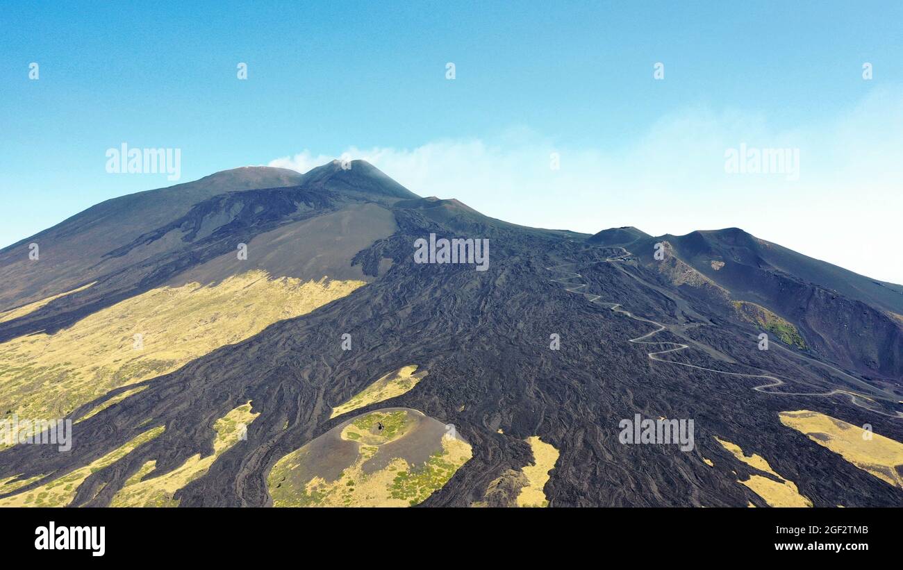 Etna volcano with old lava flow in a aerial panoramic view from above during sunny day. Stock Photo