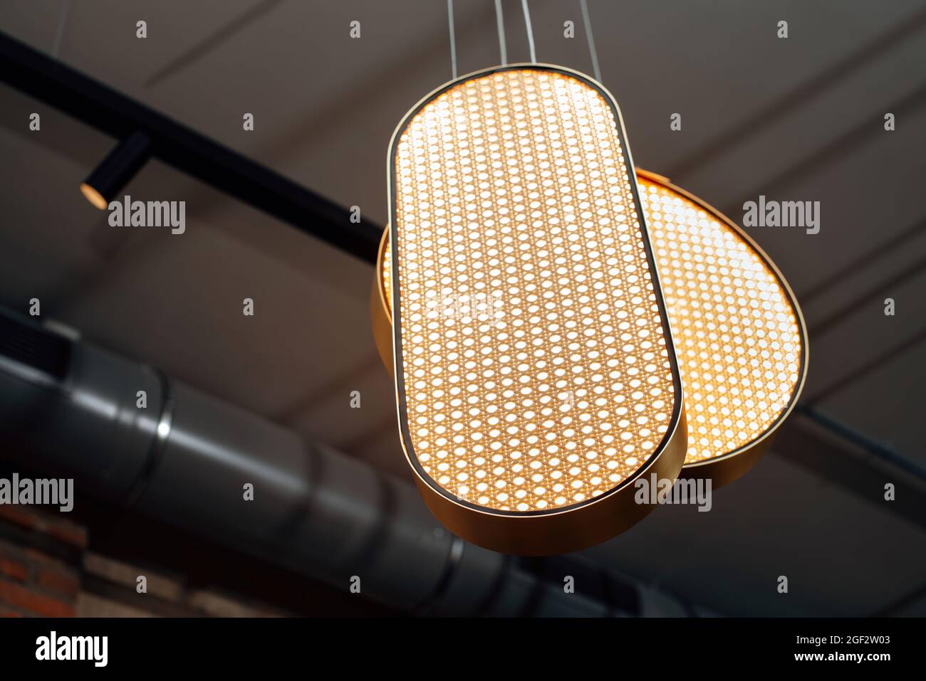 View of Stylish industrial interior. Elegant modern chandelier. Suspended led ...