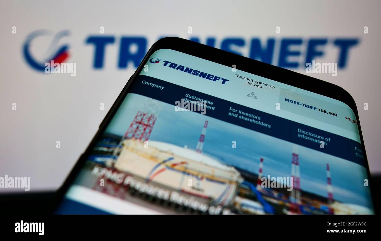 Smartphone with website of Russian pipeline company Transneft JSC on screen in front of business logo. Focus on top-left of phone display. Stock Photo