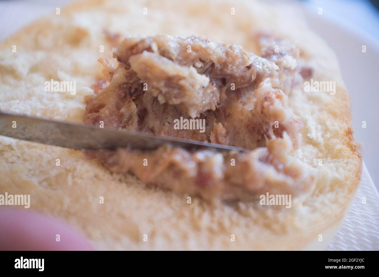 Loin zurrapa pate or lard with pork flakes been spreaded by knife. Selective focus Stock Photo