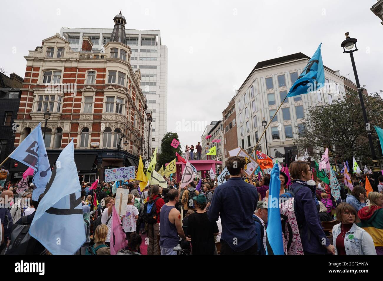 Demonstrators gather during a protest by members of Extinction Rebellion near Covent Garden, central London, at the beginning of a planned two weeks of action from the climate change protest group. Picture date: Monday August 23, 2021. Stock Photo