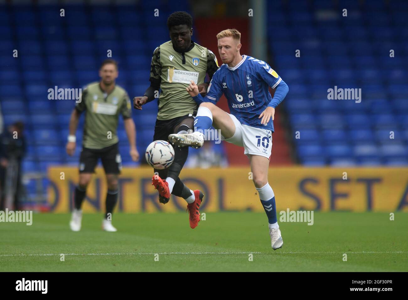 Brendan Wiredu of Colchester United does battle with Davis Keillor-Dunn of Oldham Athletic - Oldham Athletic v Colchester United, Sky Bet League Two, Boundary Park, Oldham, UK - 21st August 2021  Editorial Use Only - DataCo restrictions apply Stock Photo