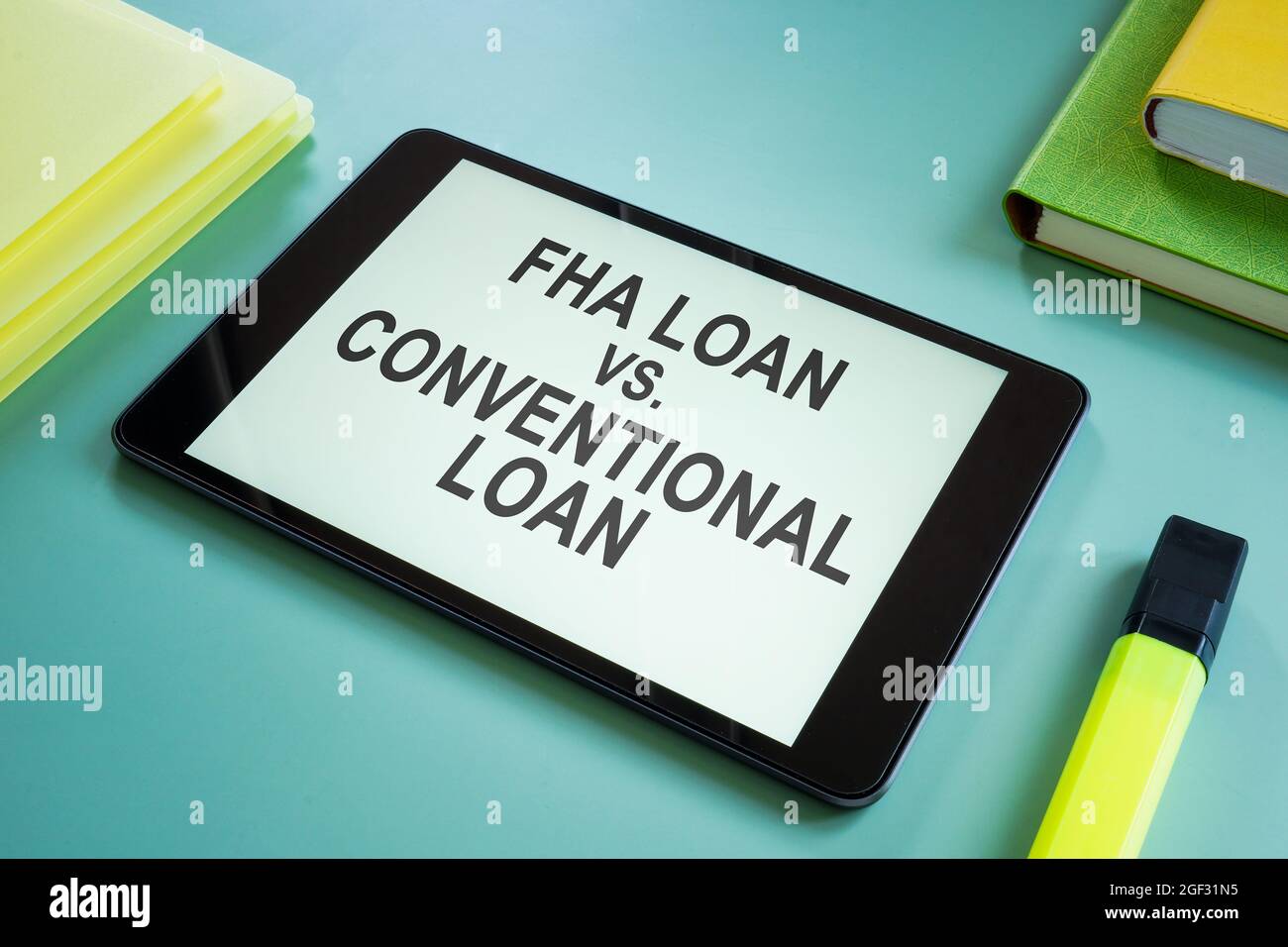 FHA loan vs Conventional loan choice for mortgage on the screen. Stock Photo