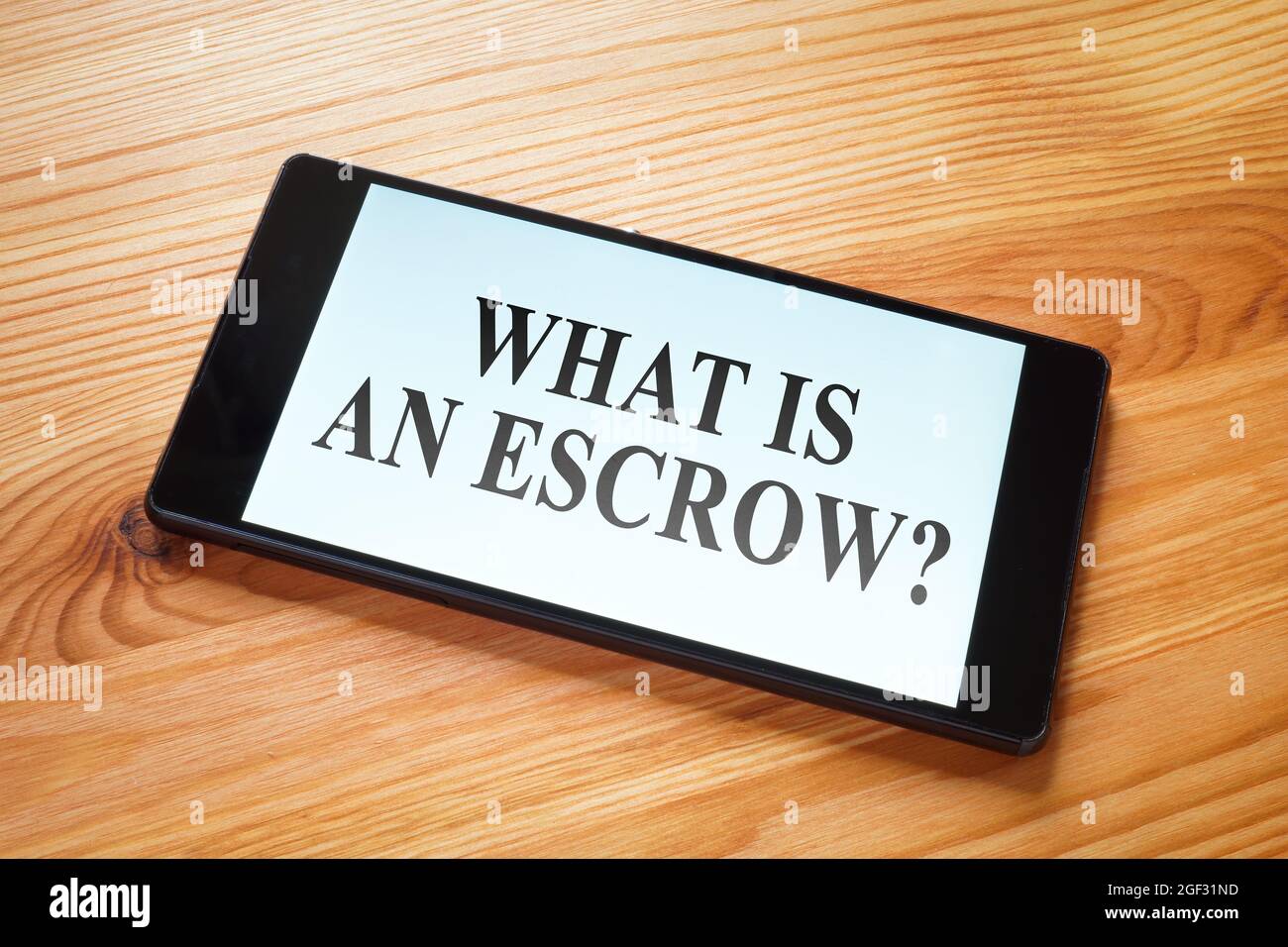 What is an escrow question on the smartphone screen. Stock Photo