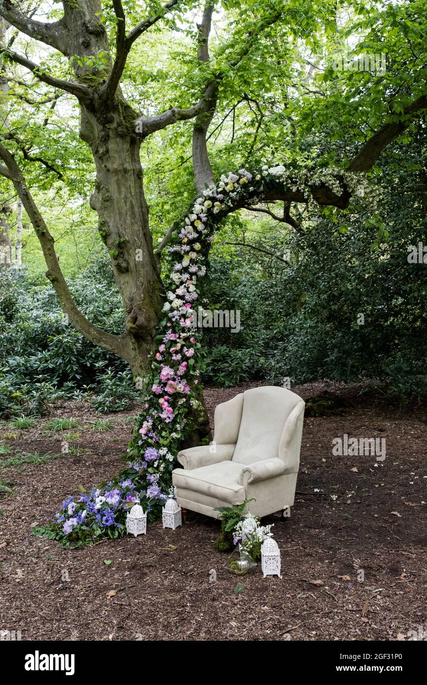 Armchair and flower garland decorations for a woodland naming ceremony