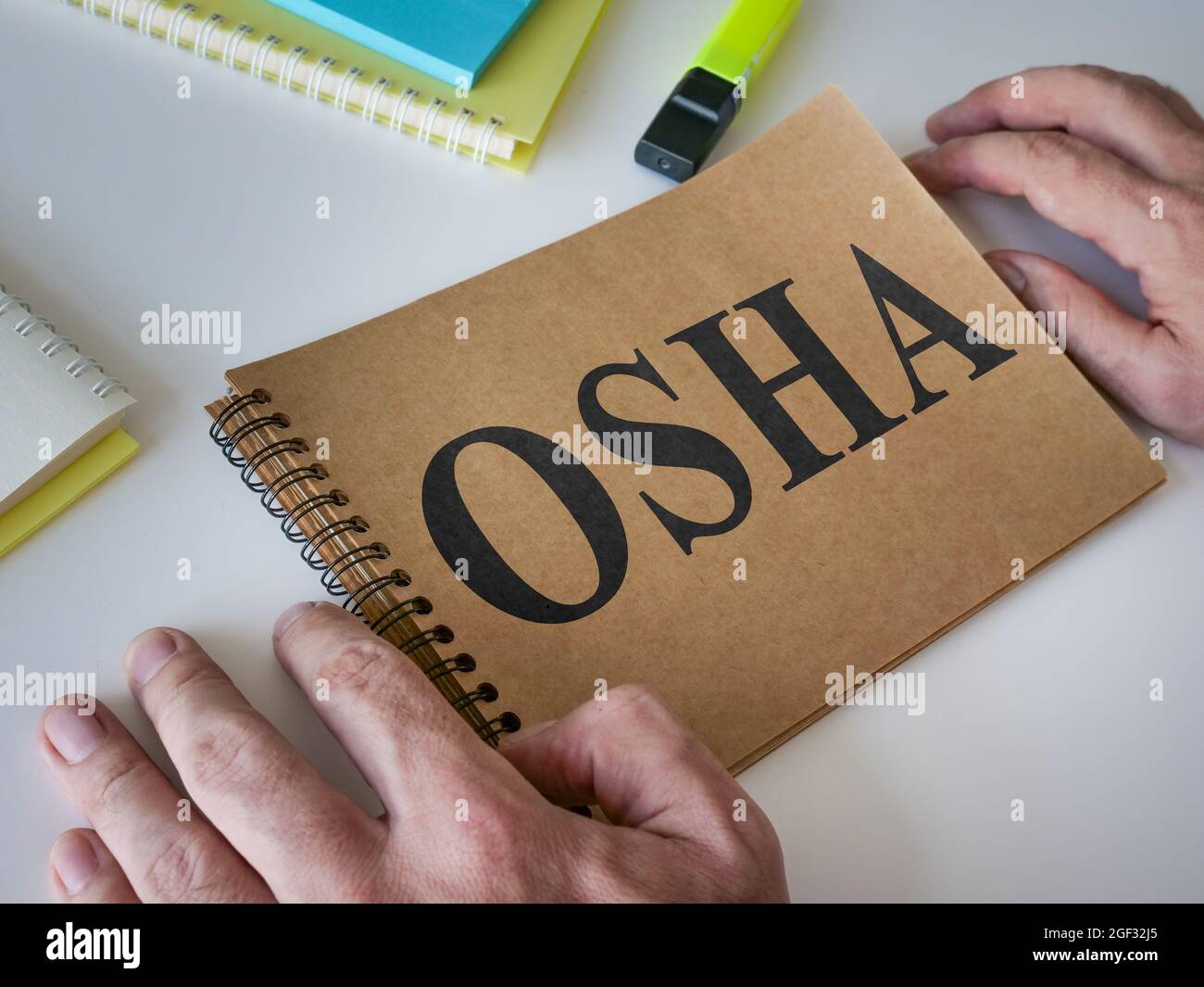 Man reads OSHA guide that is on the table. Stock Photo