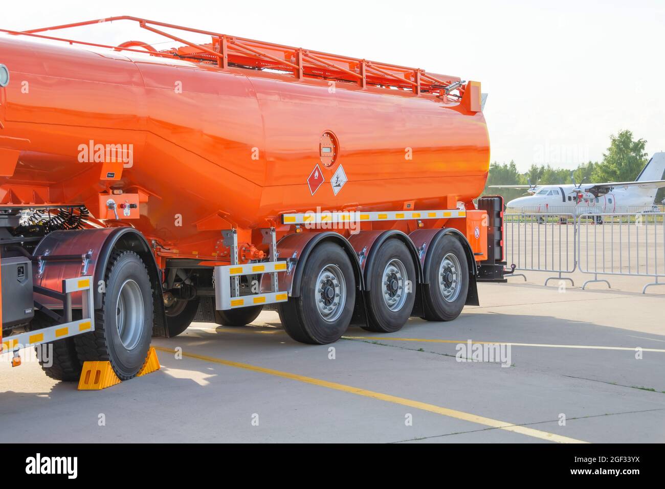 Truck releasing fuel oil stainless tanks in petrol station Stock Photo