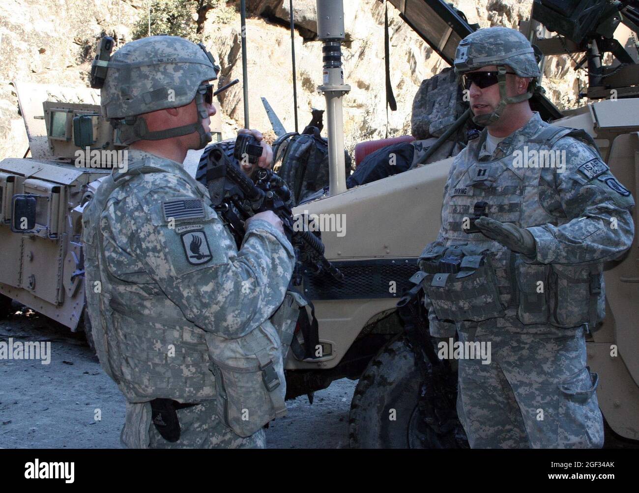 U.S. Army Capt. John Thyng discusses a vehicle recovery operation with 1st Lt. Adam Van Lear on a road in the Kunar province of Afghanistan, Jan. 23. Stock Photo