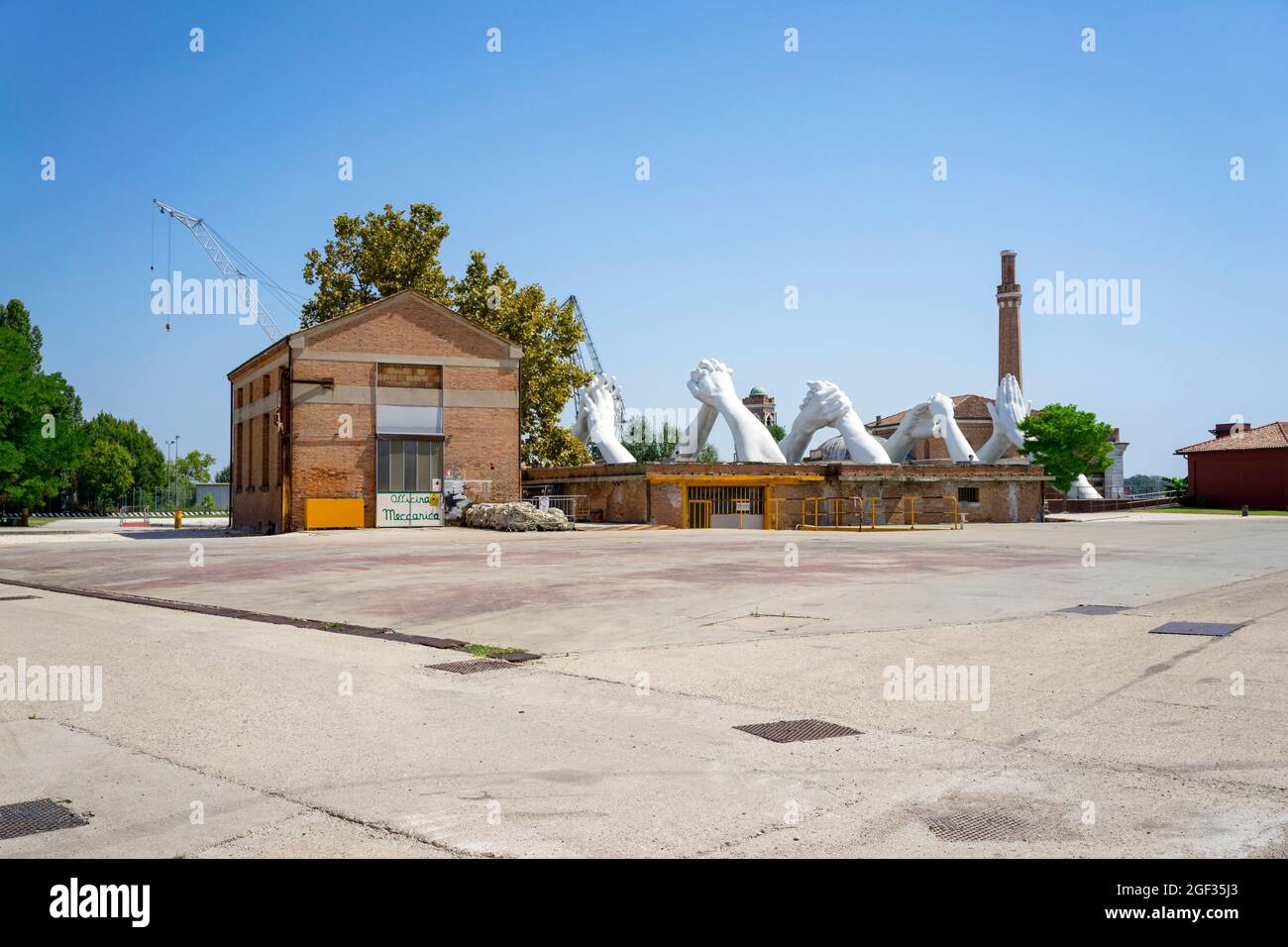 Sculpture 'Building Bridges' by Italian artist Lorenzo Quinn, installed in Venice Arsenale in 2019 Stock Photo