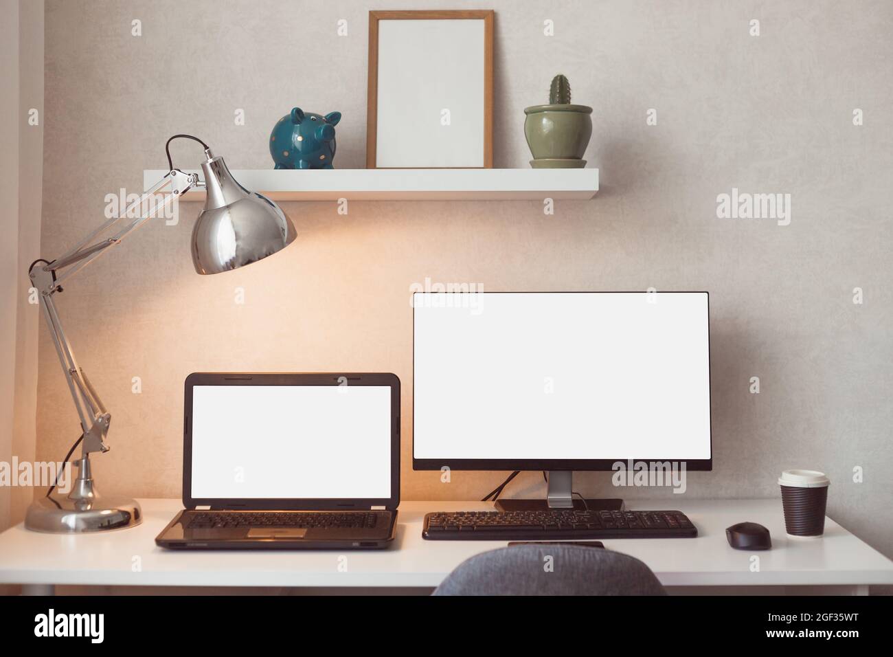 https://c8.alamy.com/comp/2GF35WT/computer-and-laptop-with-blank-white-screens-mockup-design-desktop-computer-in-office-on-white-table-with-keyboard-work-place-concept-cactus-in-pot-2GF35WT.jpg