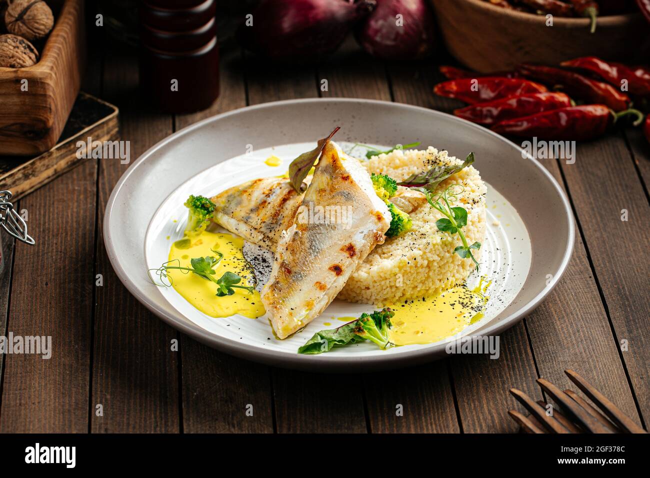Pike perch fillet on couscous and bearnaise sauce Stock Photo