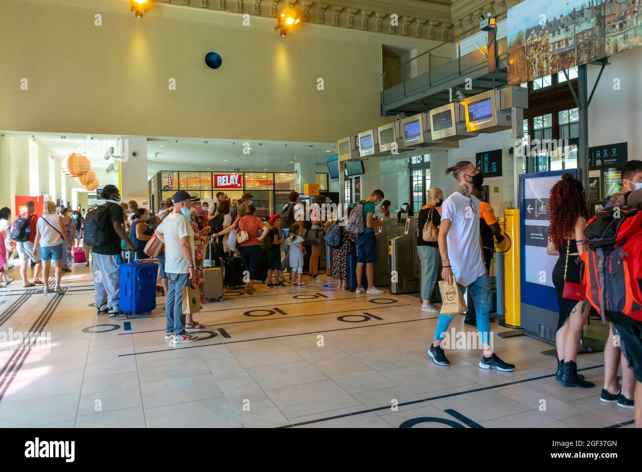 Cannes, France Crowd People inside SNCF Train Station, screens Stock