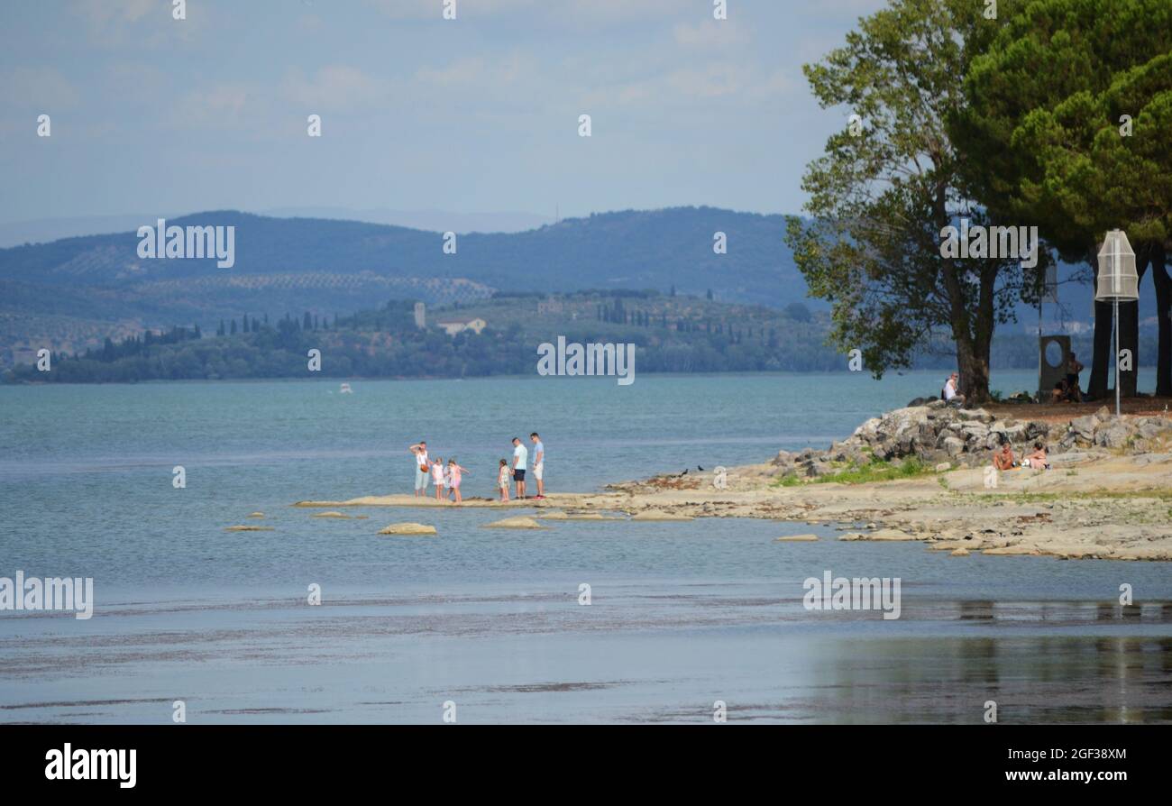 panoramic view of Trasimeno lake, A large family stands on the shore Stock Photo