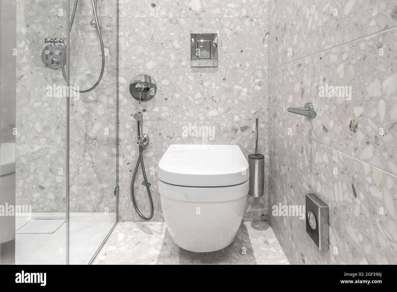 Furnished modern minimalist bathroom interior with bathroom chrome accessories and grey tiles Stock Photo