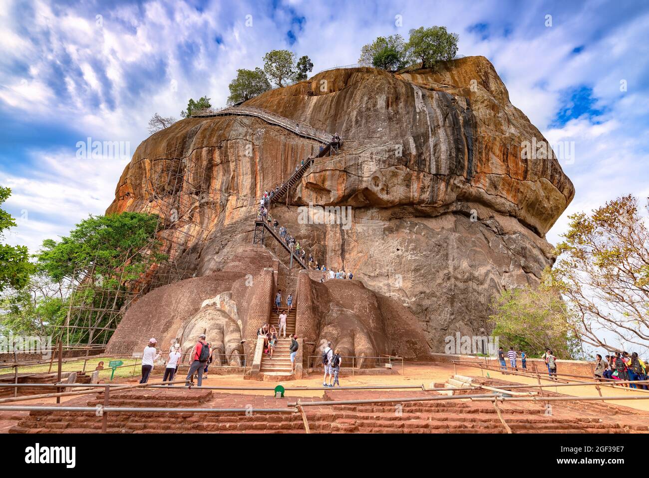 Sigiriya, Sri Lanka - August 15, 2017: A group of tourist climbing on Sigiriya rocks, at Lion gate. Sigiriya is an ancient rock fortress Stock Photo