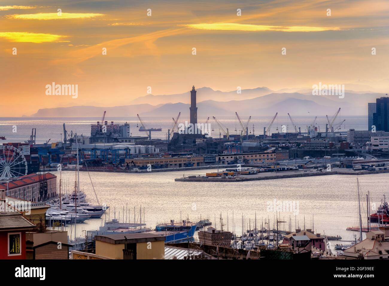 Genova, Italy - February 24, 2019: View of The Port and the lighthouse at sunset. The Port of Genoa is the major seaport of Italy Stock Photo