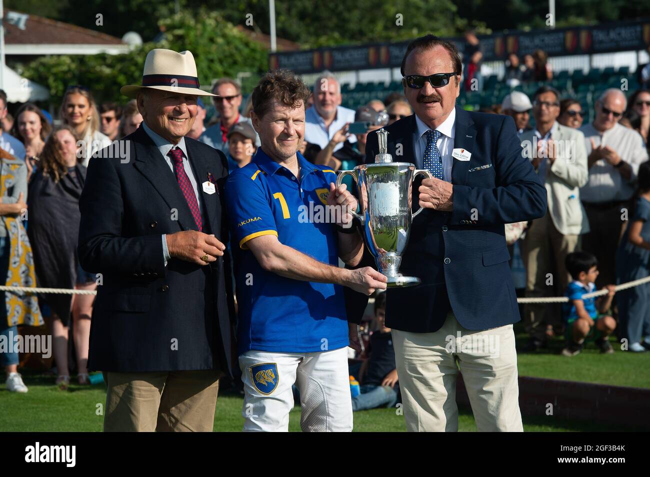 Egham, Surrey, UK. 22nd August, 2021. Polo player Andrey Borodin has a photo with Guards Polo Club Brian Stein (left) and John Collins CEO and Founder of Talacrest (right) after his team Park Place won the Talacrest Prince of Wales's Championship Cup Final at Guards Polo Club. Credit: Maureen McLean/Alamy Stock Photo