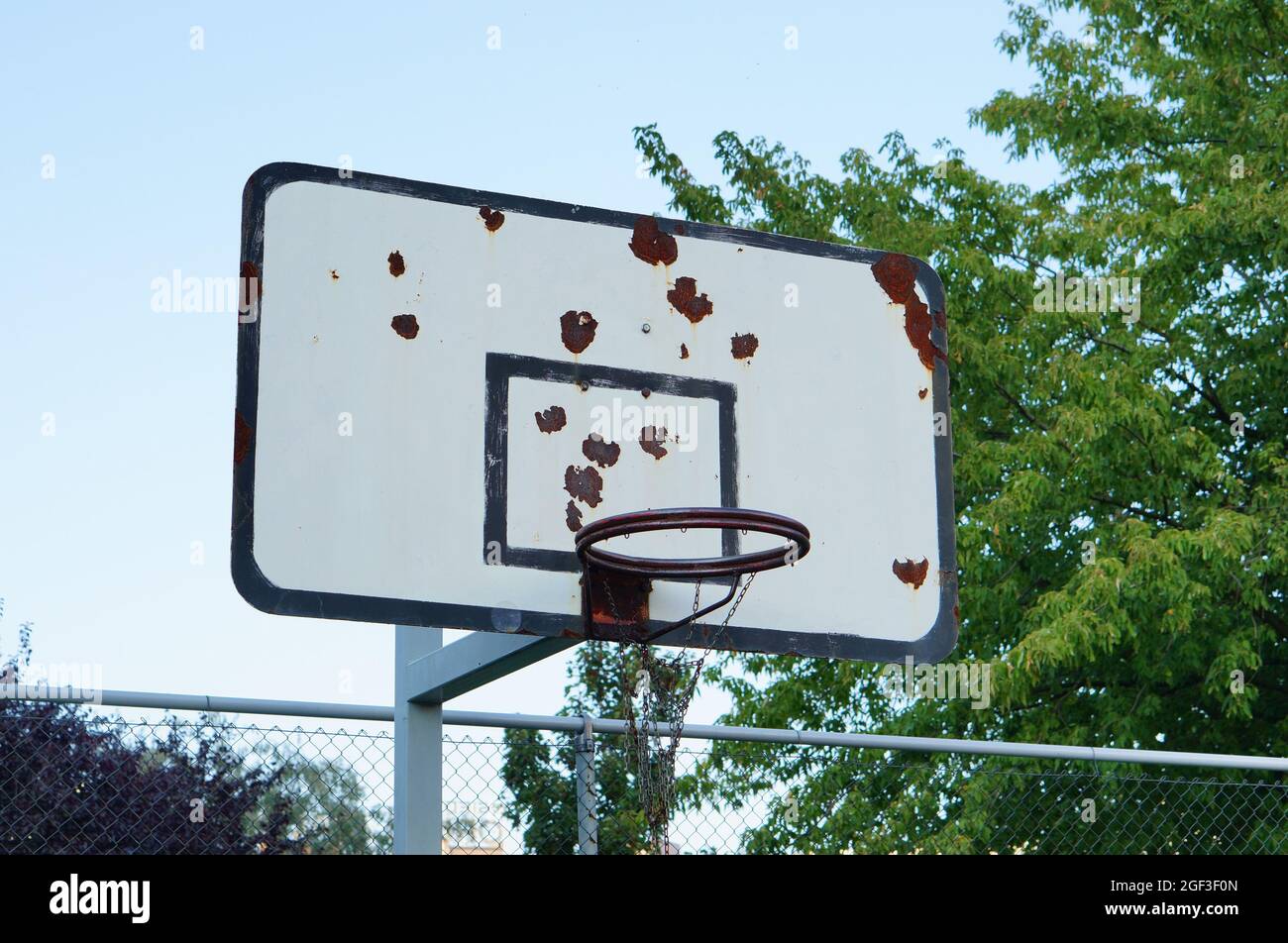 Basketball backboard under the cloudy sky near the tree Stock Photo Alamy