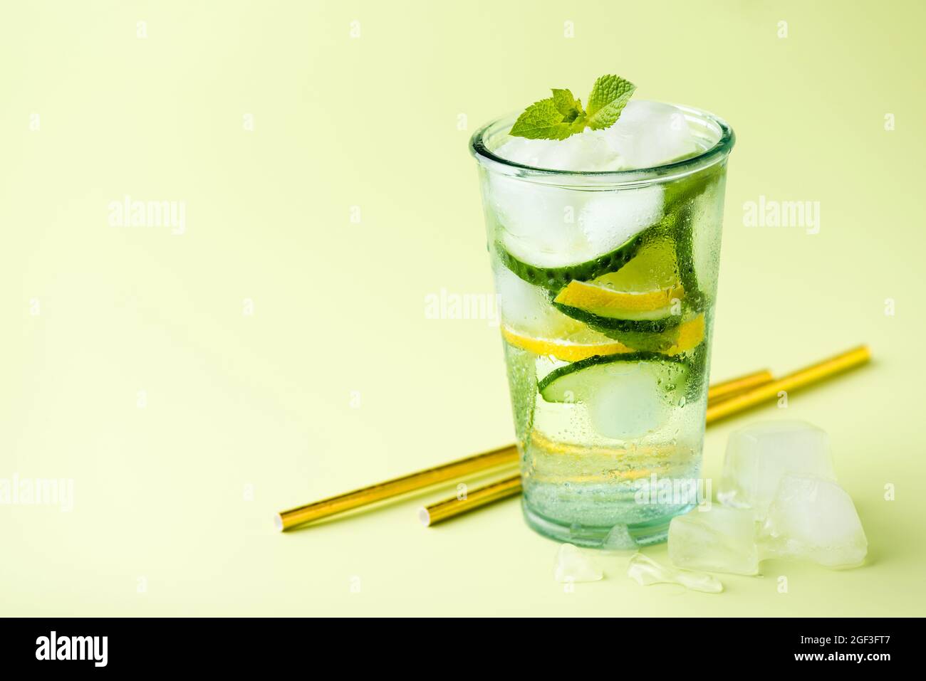 Detox cucumber lemon water in glass. Closeup view copy space. Weight loss concept Stock Photo