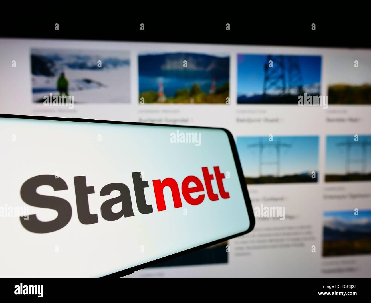 Mobile phone with logo of Norwegian electricity company Statnett SF on screen in front of business website. Focus on center of phone display. Stock Photo