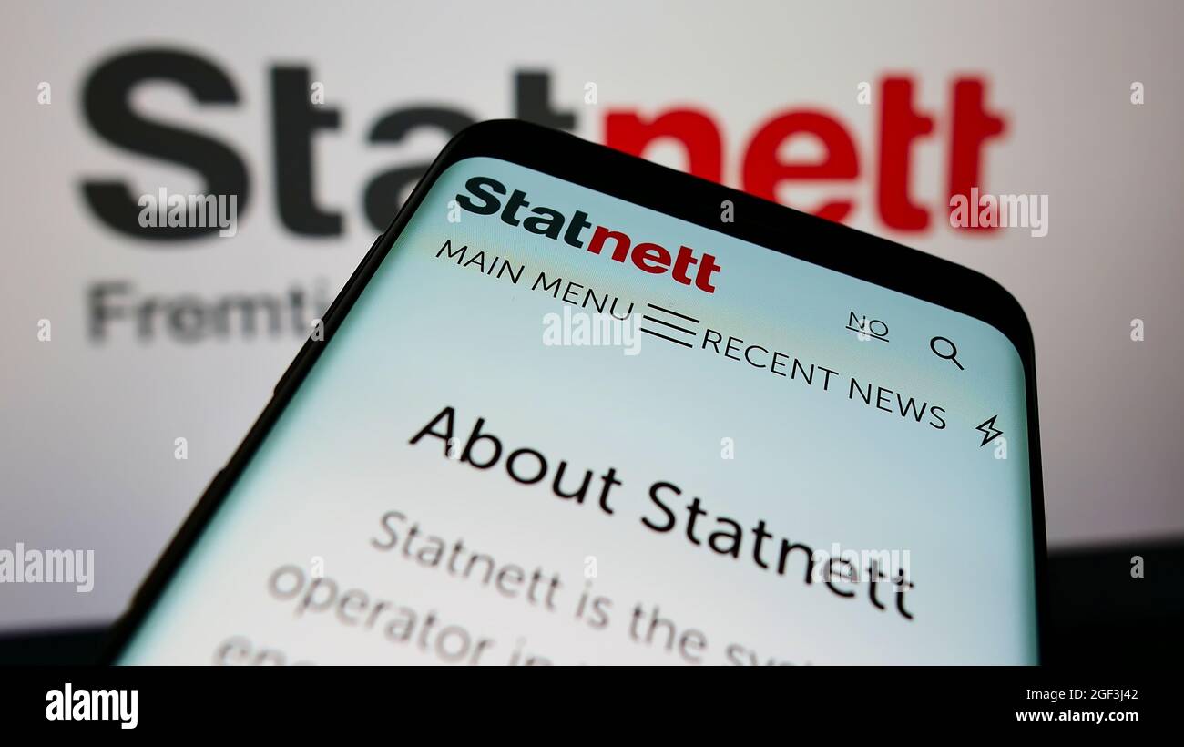 Cellphone with webpage of Norwegian electricity company Statnett SF on screen in front of business logo. Focus on top-left of phone display. Stock Photo