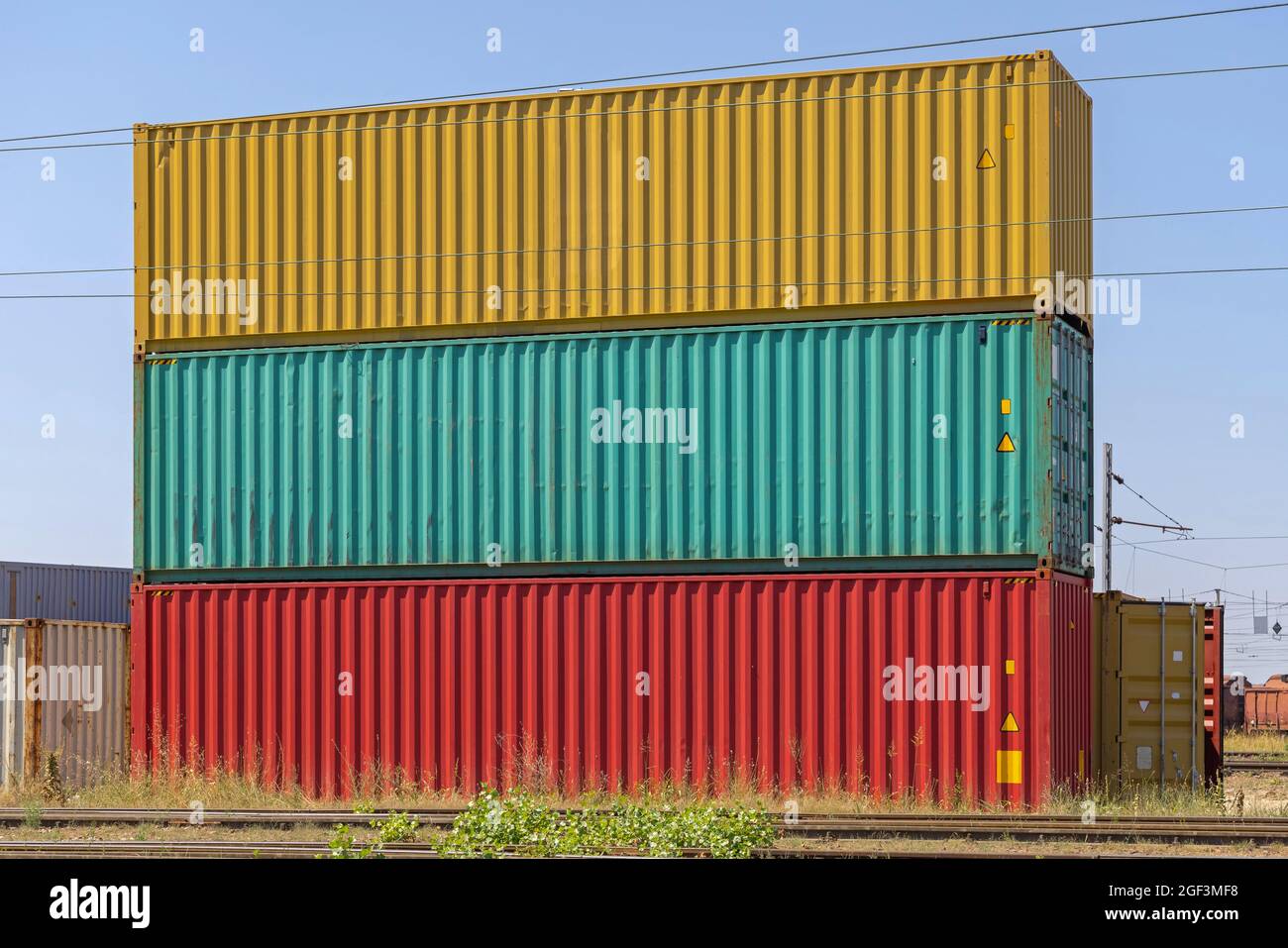 Three Colourful Cargo Containers Stacked at Railway Yard Stock Photo ...