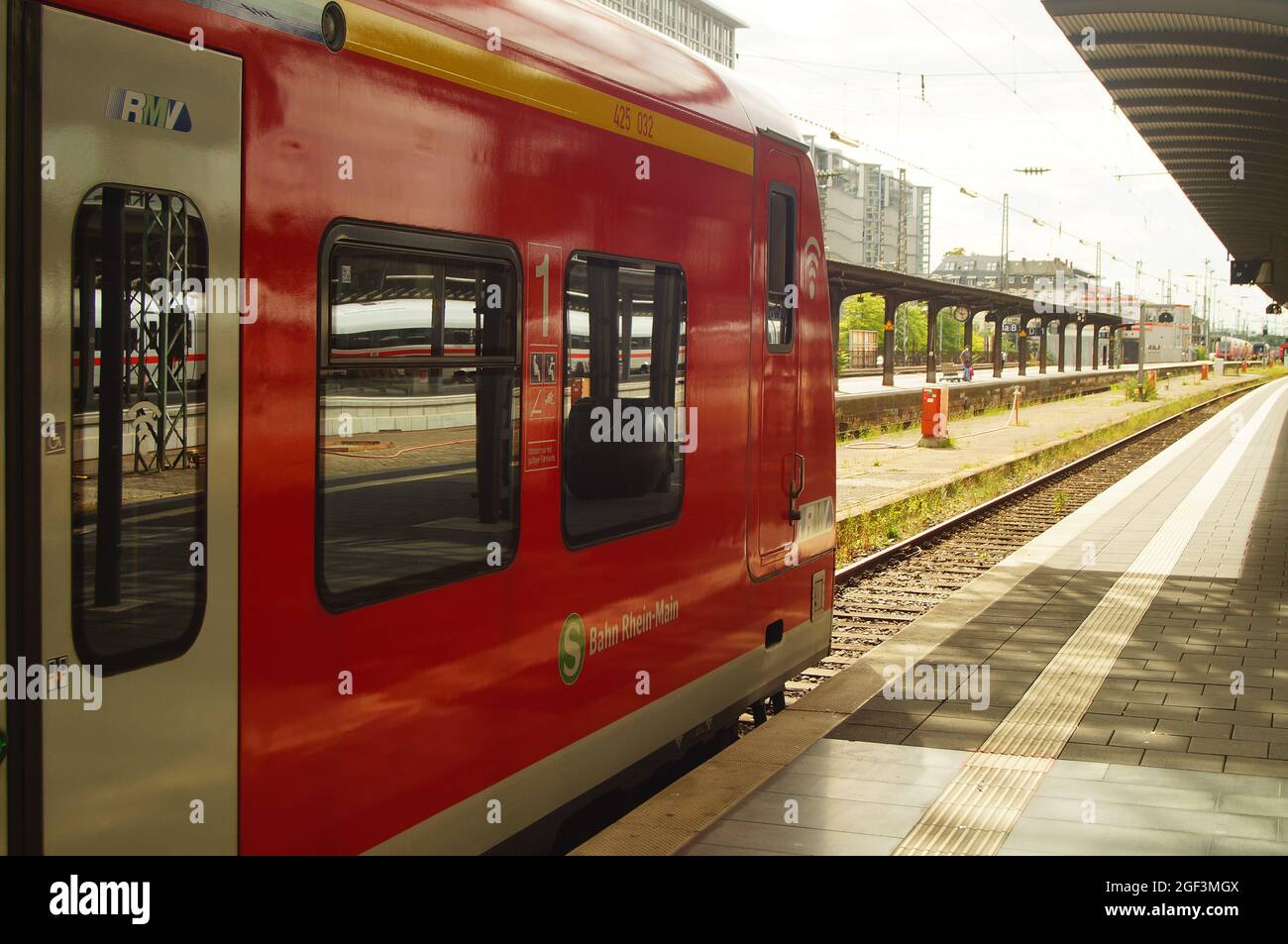 FRANKFURT, GERMANY - Aug 20, 2021: An S-Bahn at Frankfurt Central Station at the platform ready for departure. Sunny backlight with reflections. Stock Photo