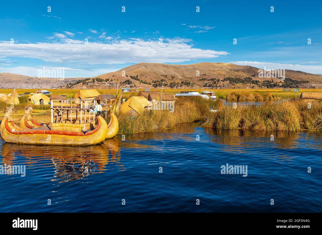 Uros floating islands with totora reed boat, Titicaca Lake, Peru. Stock Photo