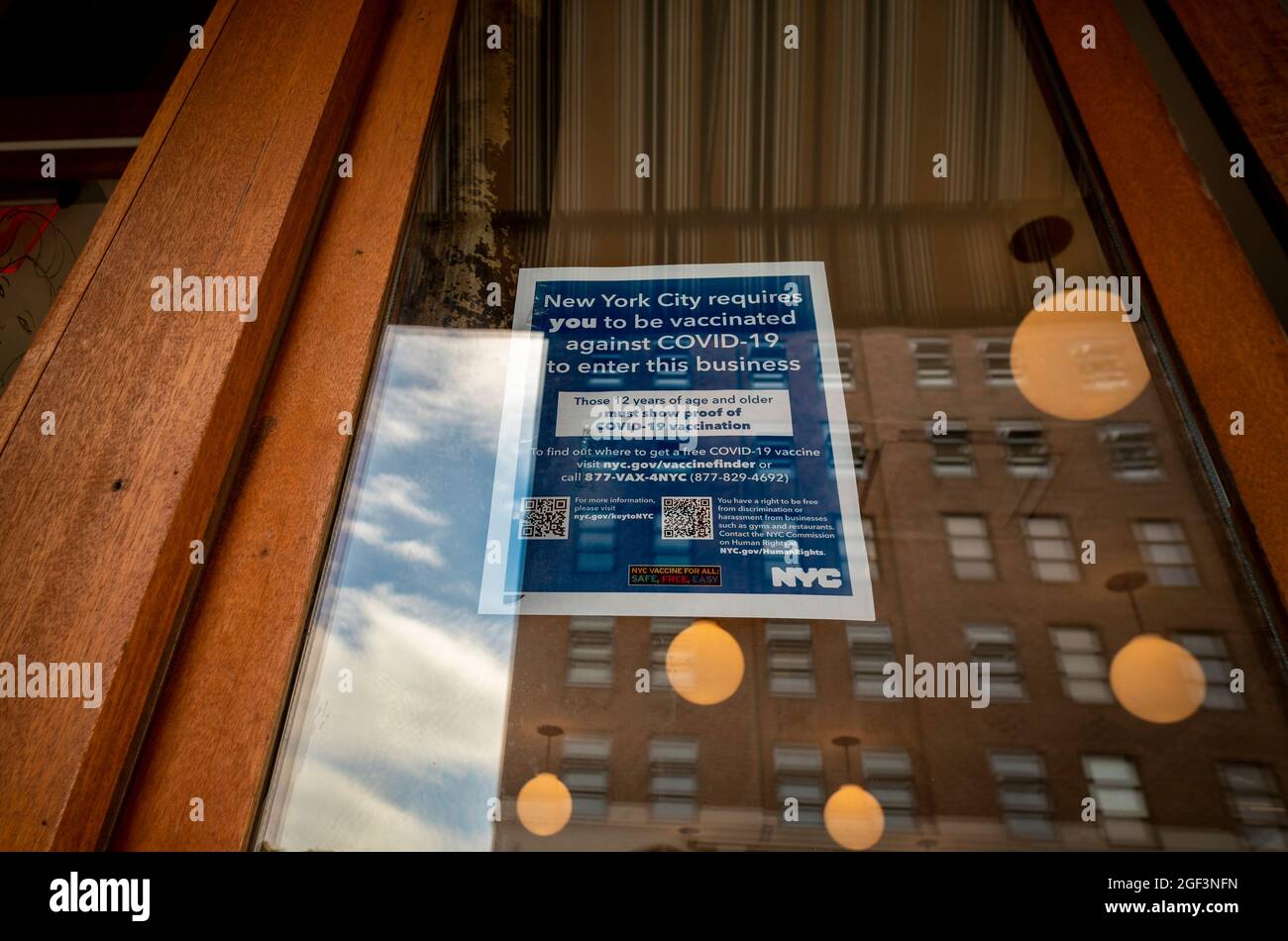 Businesses in Chelsea in New York display signs requiring proof of vaccination prior to entering on Tuesday, August 17, 2021. Indoor dining, cultural institutions, bars, gyms, theaters and other indoor venues now require individuals to show proof of vaccination prior to entering. (© Richard B. Levine) Stock Photo