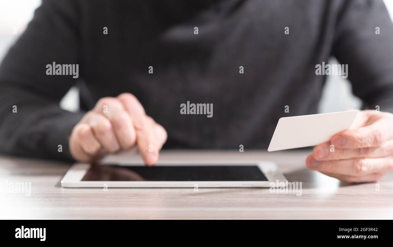 Man using his credit card for online payment Stock Photo - Alamy