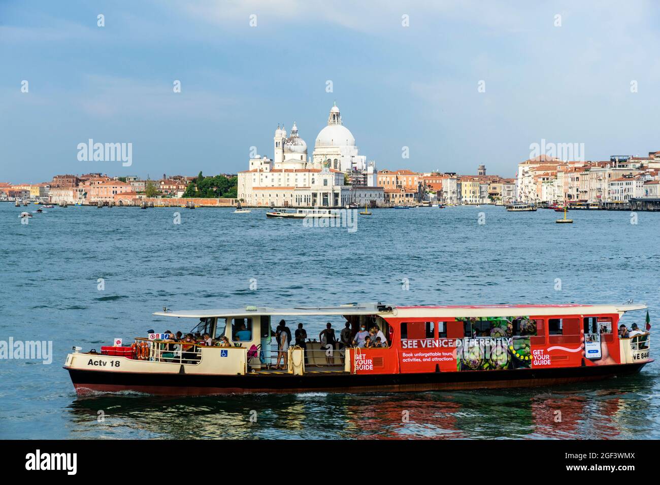 Venice laguna with Santa Maria della Salute and passenger boats Stock Photo