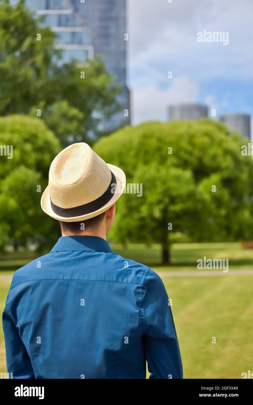 A young man in a hat, employee before an interview looks at an office