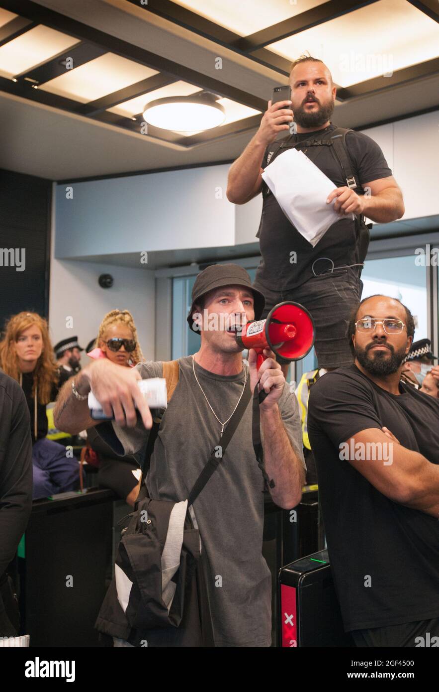 London, UK. 23rd Aug, 2021. A protester is seen shouting slogans on a megaphone inside ITV reception after storming ITV in Grays Inn Road during a protest.Protesters storm ITV in Grays Inn Road to demand a debate about vaccine safety especially for children. Protesters are also against the vaccination passport as they believe it takes away valuable freedoms. Credit: SOPA Images Limited/Alamy Live News Stock Photo