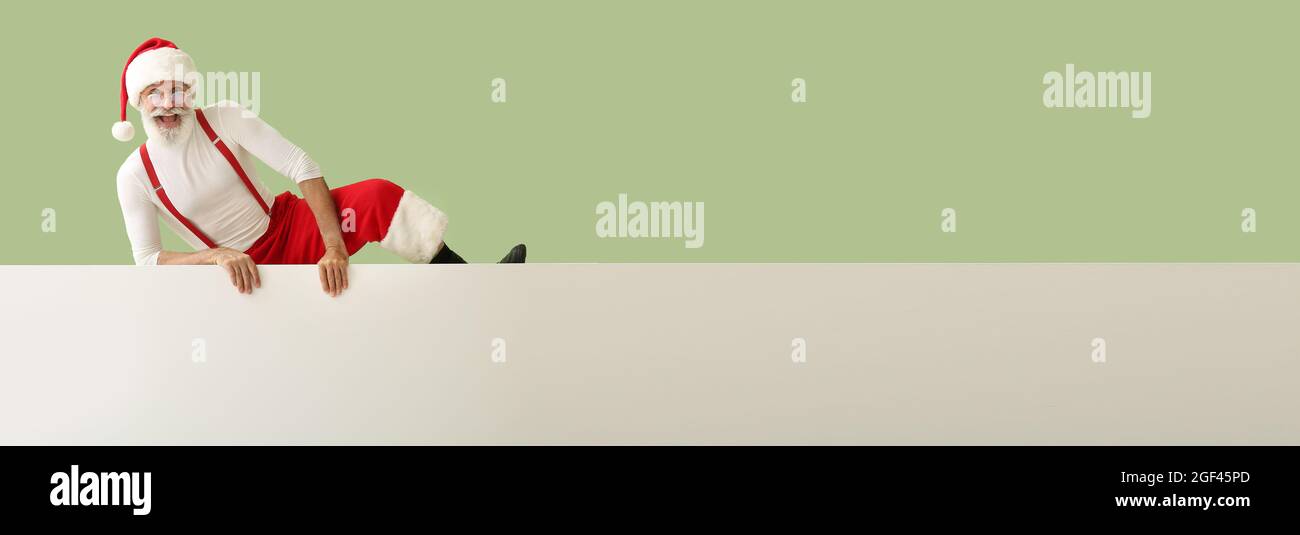 Happy Santa Claus with blank poster on color background with space for ...