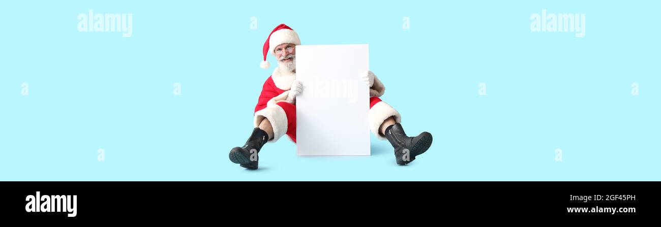 Santa Claus with blank poster on color background with space for text ...