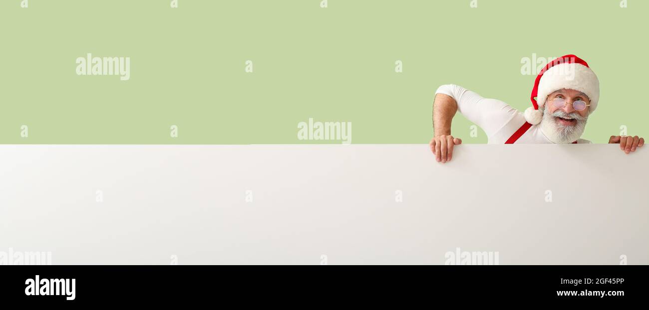 Happy Santa Claus with blank poster on color background with space for ...