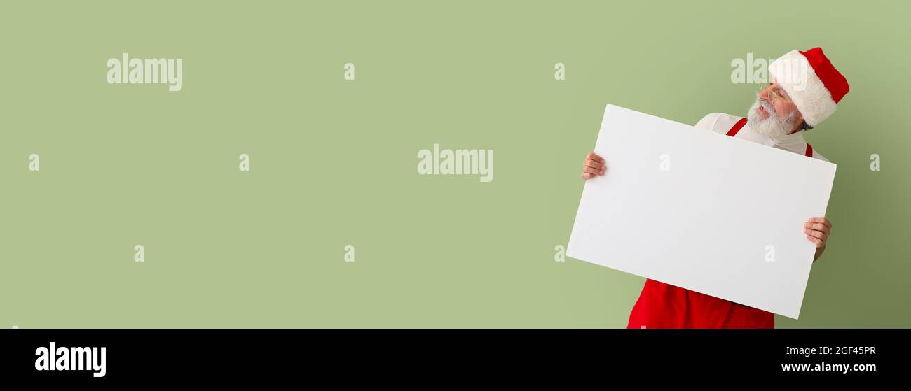Santa Claus with blank poster on color background with space for text ...