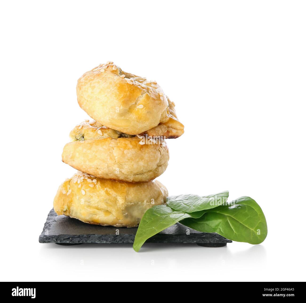 Puff pastry stuffed with spinach on white background Stock Photo