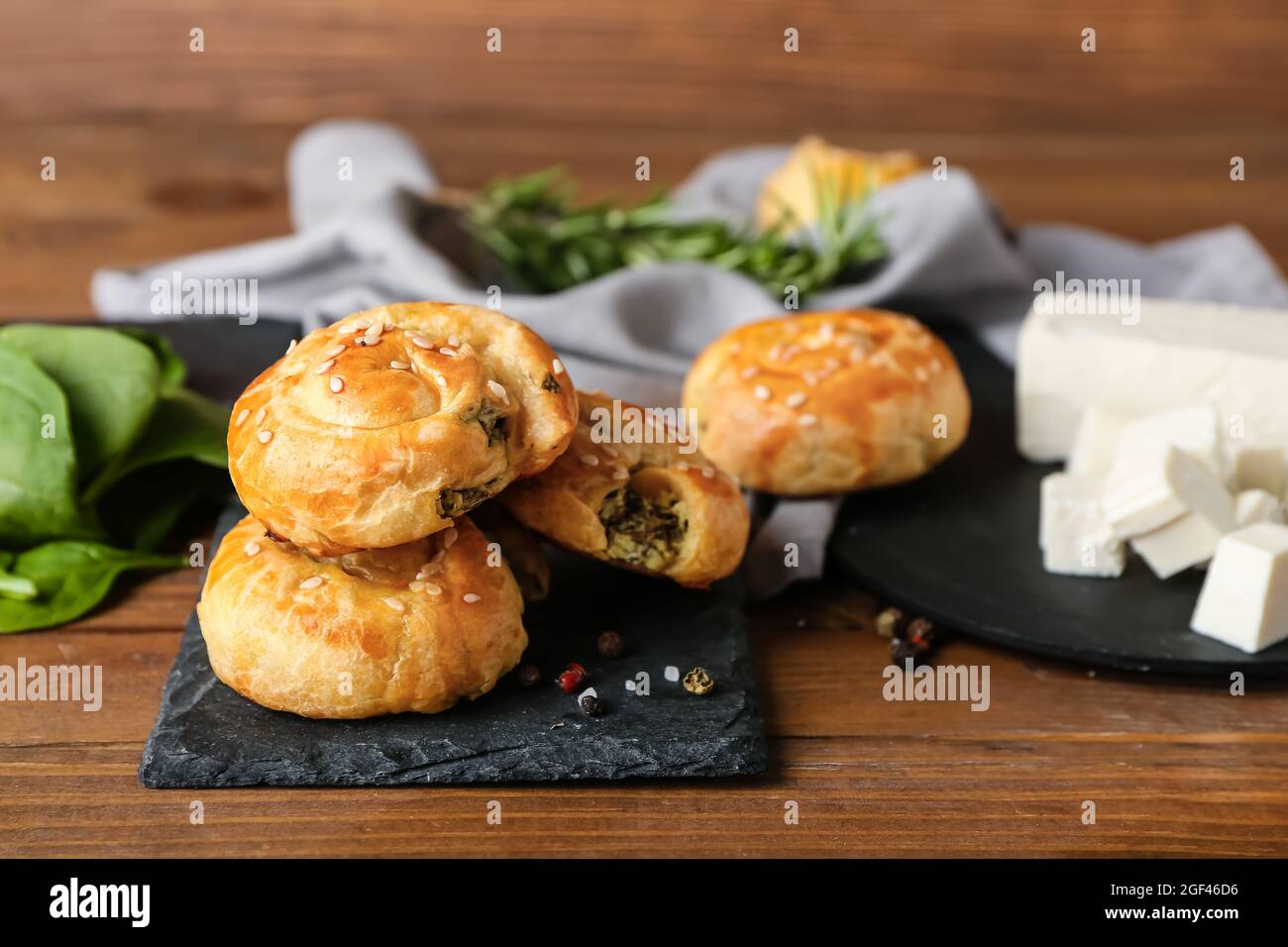 Puff pastry stuffed with spinach on table Stock Photo