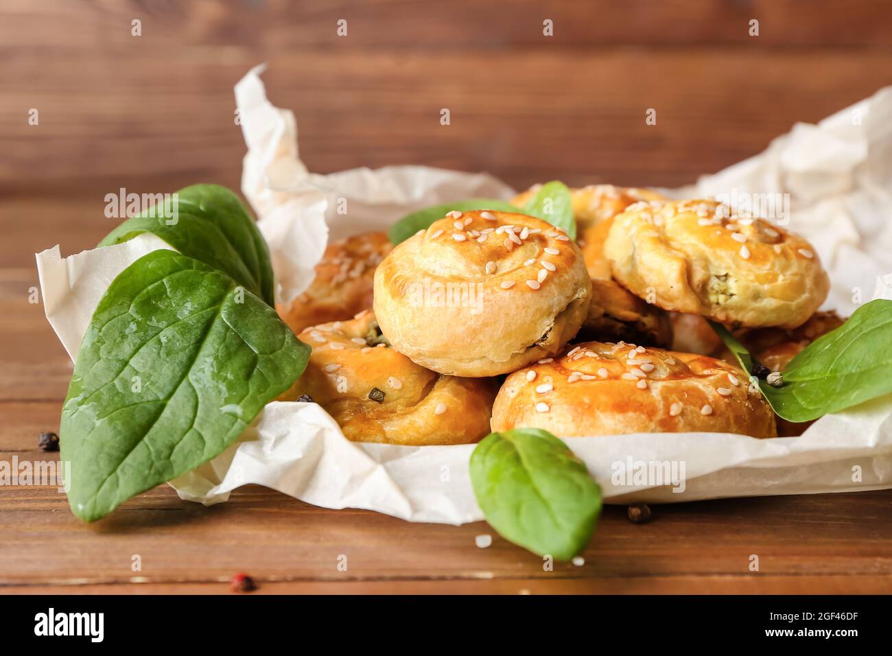 Puff pastry stuffed with spinach on table Stock Photo