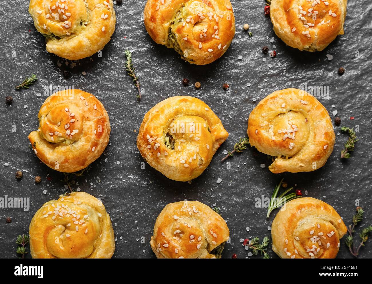 Puff pastry stuffed with spinach on board Stock Photo