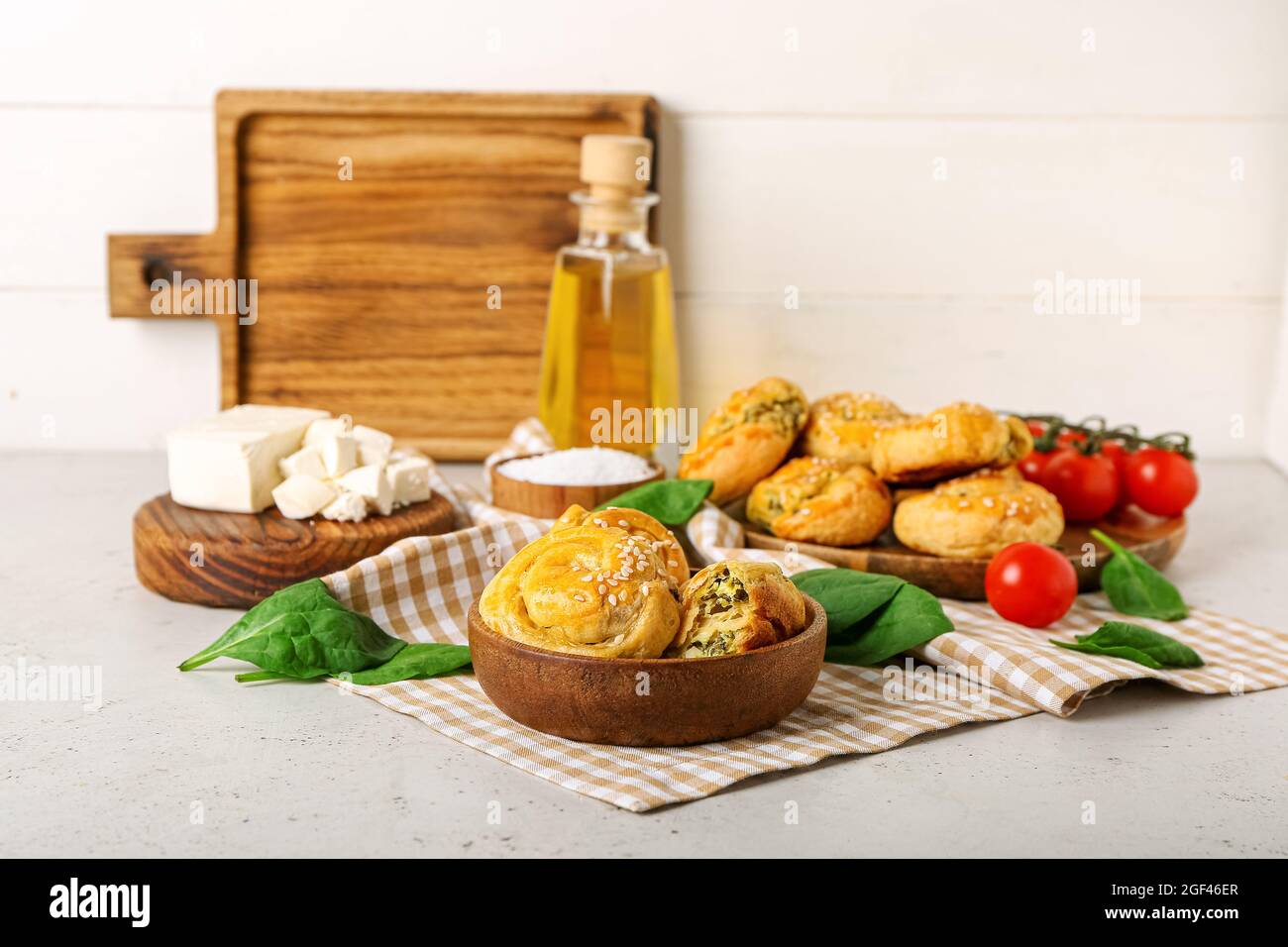 Puff pastry stuffed with spinach on table Stock Photo - Alamy