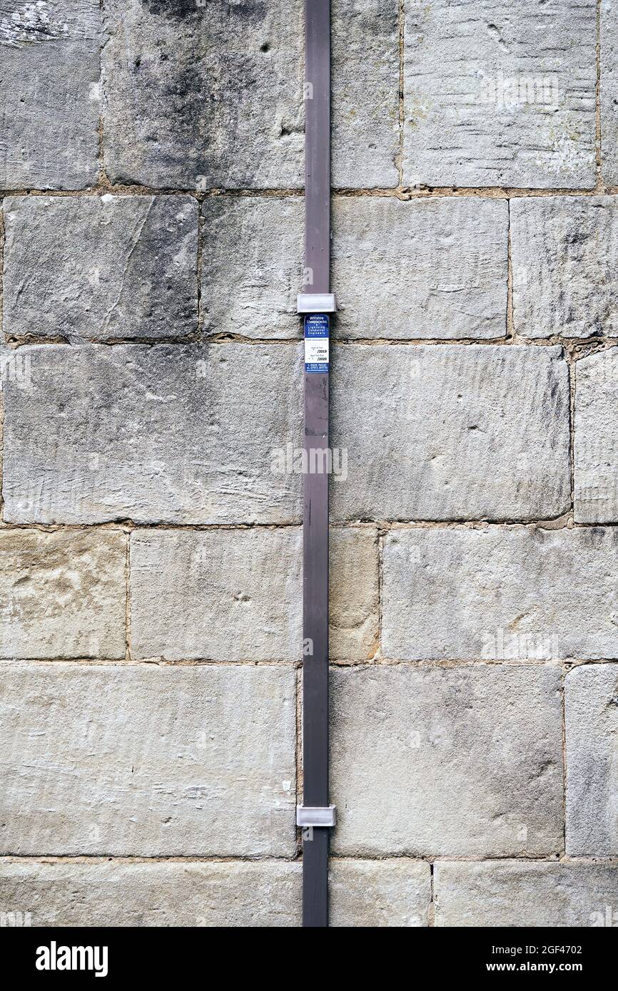 Metal lightning conductor attached to old stone wall Stock Photo